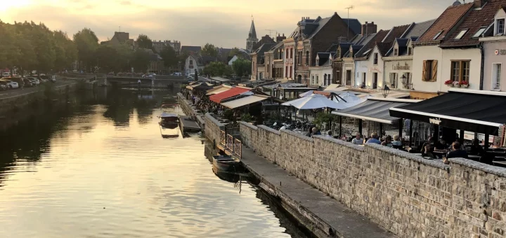 Night view of Amiens cathedral and bustling Saint-Leu district bars